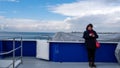 Karsikaya, Izmir, Turkey- 02/06/2020: Female passenger on the KarÃÅ¸ÃÂ±yaka Ferry is looking at her phone.